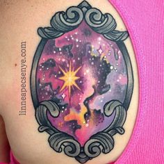 a woman's back with a tattoo on her shoulder and stars in the sky