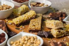 several bowls and plates filled with different types of food on top of a wooden table