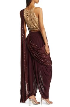 Elegance is achieved in an enticing outift that includes a midriff-baring top, dance-all-night dhoti pants and an attached dupatta that's easy to drape. The booti-work drape is attached to the outfit, so you don't have to worry about pleats or the right draping—just wrap it around and over your shoulder. 27" inseam, 11"l leg opening, 16" top (size medium) Halter neck Spaghetti straps On-seam pockets Pants and drape feature hook-and-eye attachments for easy adjustments Lined 100% viscose Spot cle Luxury Elegant Blouse Piece With Cutdana, Luxury Designer Sherwani For Navratri, Luxury Self Design Sherwani For Navratri, Luxury Elegant Chanderi Bandhgala, Semi-stitched Bollywood Blouse Piece, Luxury Silk Sherwani For Navratri, Luxury Sherwani With Self Design For Navratri, Luxury Sherwani With Traditional Patterns For Navratri, Luxury Bollywood Art Silk Bandhgala