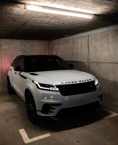 a white range rover parked in a parking garage