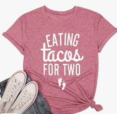 a t - shirt that says eating tacos for two on it next to sneakers