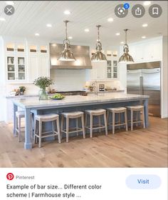 a large kitchen island with four stools next to it