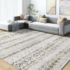 a living room with a large rug and couches