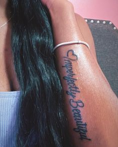 a woman with long hair has a tattoo on her arm that reads, i love you to the moon and back