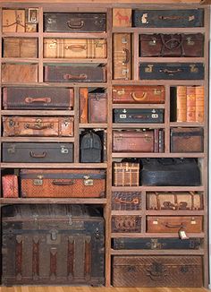 an assortment of suitcases are stacked on top of each other in a bookcase