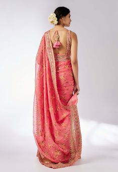 Embrace elegance with this delicate floral jaal sari, featuring layered frills, flounce, and an intricately embroidered border. The easy wrap design is complemented by a classic sleeveless printed blouse that adds a touch of glamour and glitz, making this ensemble perfect for any special occasion. Frill Saree, Pink Sari, Easy Wrap, Nyc Studio, Embroidered Border, Indian Textiles, Western Wedding, Wedding Service, Indo Western