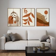 a living room with three paintings on the wall