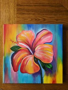 a painting of a flower on a wooden table