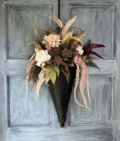 a vase filled with flowers sitting on top of a door