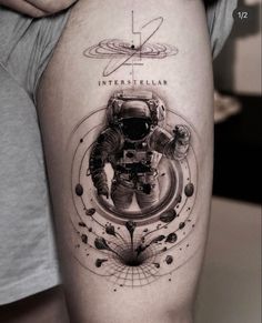 an astronaut tattoo on the thigh