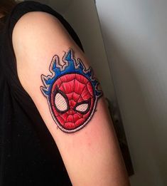 a person with a spiderman tattoo on their arm