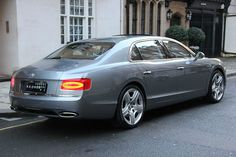 a silver car parked on the side of the road