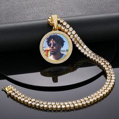 Our customized photo pendant and hip hop necklace is an iced-out necklace made from 18K gold plated and AAAAA Cubic Zirconia. It allows you to honor your loved ones, friends, and pets by using their photos on the pendant which brings good memories every moment. The Pendant comes with a rope necklace. You can make your own pendant by uploading high-quality photos that can be cropped and customized for you. Iced Out Cubic Zirconia Round Pendant Necklaces, Personalized Diamond Cuban Link Necklace, Personalized Cuban Link Diamond Necklaces, Iced Out Cubic Zirconia Round Pendant Necklace, Gold Iced Out Round Tennis Necklace, Gold Iced-out Tennis Necklace, Iced Out Pendant Necklace For Streetwear, Streetwear Iced Out Pendant Necklace, Gold Bling Tennis Necklace For Gift