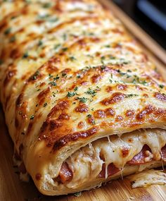 a cheesy pizza on a wooden cutting board