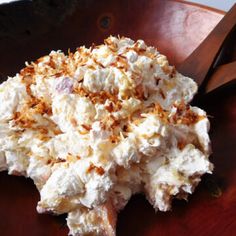 a wooden table topped with a pile of food next to a pair of large scissors