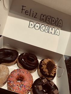 a box filled with lots of different flavored donuts