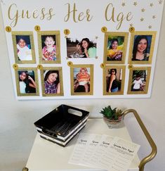 a table with pictures on it next to a sign that says guess her age and a potted plant