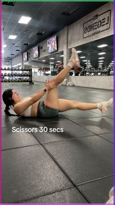 a woman is doing an exercise on the floor