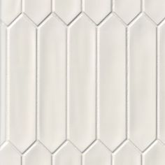 white hexagonal tiles are arranged in rows and diagonals to create a geometric pattern