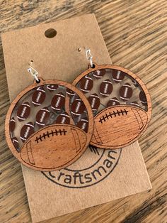 two wooden earrings with footballs on them