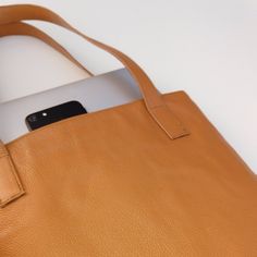 Everyday Genuine Leather Tote Bag. Excellent for work, pleasure, busy mom or trendy world traveler. Handcrafted in Pakistan. Material: Cow grain genuine leather Strong Non Adjustable Strap OPen Closure Internal zippered pocket 7" x 12" Internal open leather pocket 5" x 3.5" Dimensions: 14" x 12" x 4" Weight: 1 lbs. 8 oz. Mustard Tote Bag For Everyday Use, Mustard Shoulder Bag Tote With Removable Pouch, Mustard Tote Bag With Adjustable Strap, Yellow Soft Leather Tote Bag, Orange Eco-friendly Shoulder Bag For Everyday, Everyday Tote Bag, Leather Pocket, Genuine Leather Totes, Everyday Tote