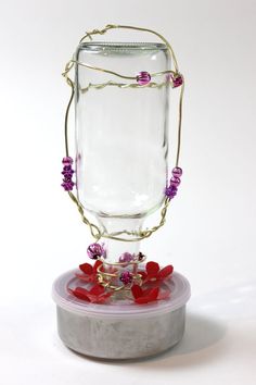 a glass jar with some flowers in it