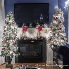 christmas tree decorated with red and white ornaments in front of a tv mounted on a fireplace mantel