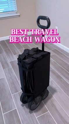 a black suitcase sitting on top of a tiled floor next to a window with the words best travel beach wagon