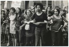 black and white photograph of women protesting in front of a building with signs on it