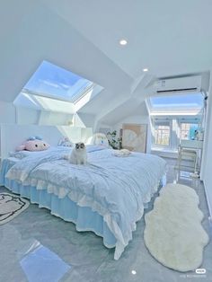 a cat sitting on top of a bed in a room with white walls and ceilings