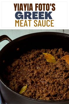 a close up of food in a pan on a table with the words vava foto's greek meat sauce