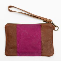 Stylish and durable, this Eastport Clutch is made to accompany you on all of your travels. Perfect for those on the go! Attach the Eastport Clutch to the inside of the Saco River tote Bag or the Fore Street Tote Bag (sold separately) to make a stylish set. Due to the nature of the leather, variations in color may occur. Made in a solar-powered workshop in Maine. Includes detachable leather wrist strap with a bronze lobster clasp built-in leather hand clutch strap zip-top closure Materials waxed