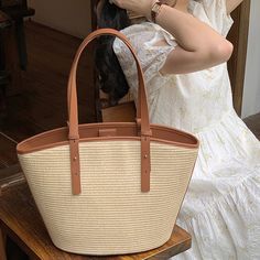 Add a summer-inspired touch to your accessories edit with this straw bucket tote bag. Woven from straw with leather trimmings, this handbag makes us look forward to summer and escapism. It comes with an open top and is roomy enough for all your essentials. Easy-to-wear wardrobe staples that combine classic and contemporary styles.Width (cm): 28 cmHeight (cm): 16 Color: Light brownInterior Material: Polyester CottonMaterial_bag: StrawBagType: Handbag & Shoulder bagBag Length: 28 cm Spring Shopping Jute Shoulder Bag, Spring Large Capacity Jute Bucket Bag, Straw Beach Bag For Shopping, Large Capacity Jute Bucket Bag For Spring, Chic Beach Bag With Bamboo Handle For Travel, Elegant Bucket Bag With Braided Handles For Beach, Chic Beach Bag With Bamboo Handle, Chic Shoulder Bag With Bamboo Handle For Beach Season, Elegant Beach Bag With Leather Handles For Vacation