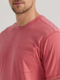 a man in a red shirt is looking at the camera with a serious look on his face