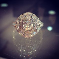 an antique diamond ring sitting on top of a table