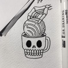 a drawing of a skull in a coffee cup