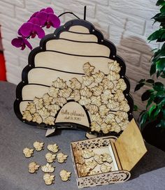 a table topped with lots of cookies next to a potted plant and vase filled with flowers