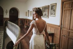 a woman in a wedding dress standing on a staircase