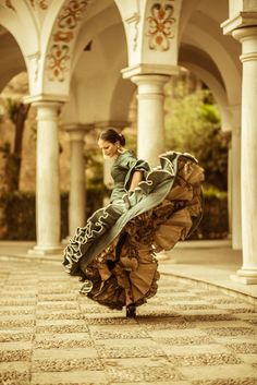 a woman in a green dress is dancing