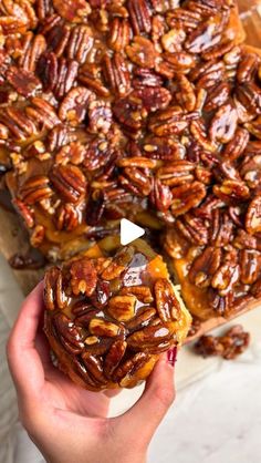 someone holding up a piece of pecan pie