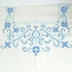 a white table cloth with blue designs on it