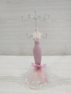 a dress on a hanger with a pink ribbon around it and the word happy written above it