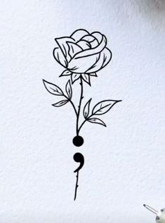 a black and white drawing of a rose on a wall with the word love written in it