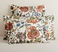 two pillow cases with floral designs on them