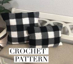 two black and white crochet pillows on a bench next to a potted plant