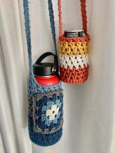 two crocheted purses hanging on the wall with one holding a soda can