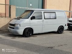 a white van parked in front of a building