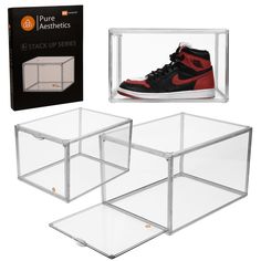 a pair of sneakers in a clear box with the packaging behind them and an orange shoe on top