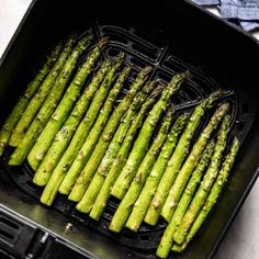 asparagus being cooked in an air fryer