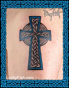 a celtic cross tattoo on the back of a woman's upper arm and shoulder